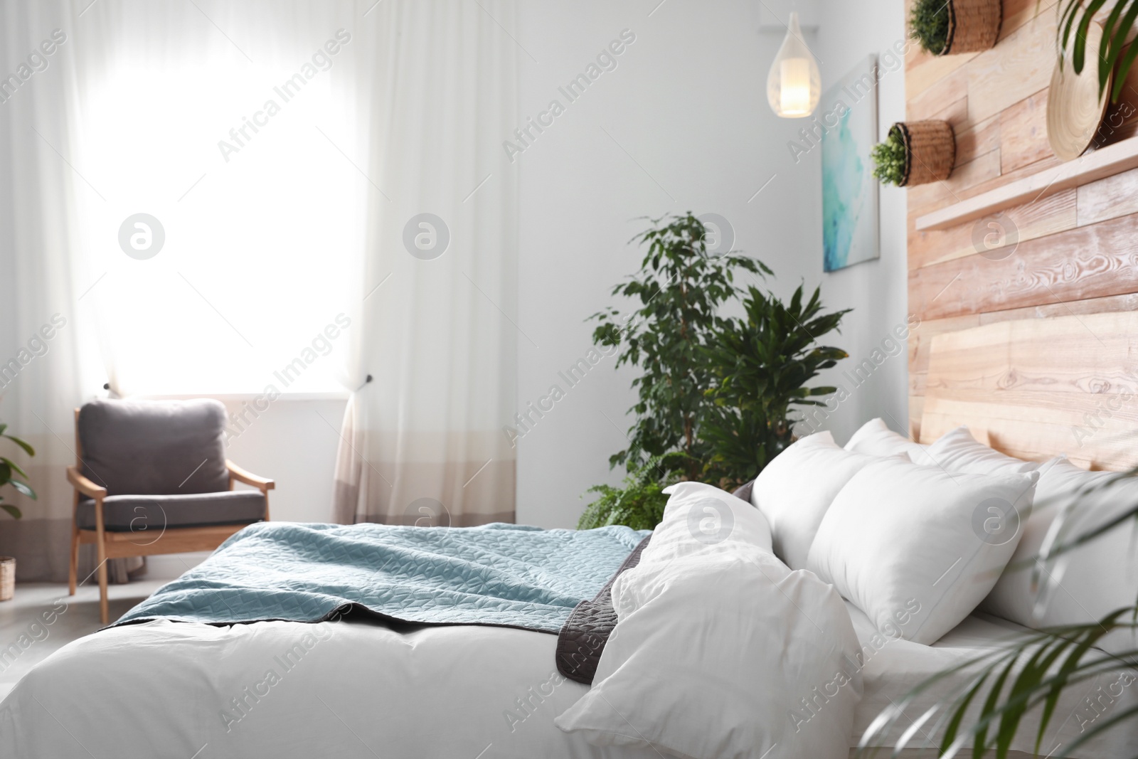 Photo of Cozy bedroom decorated with green plants. Home design ideas