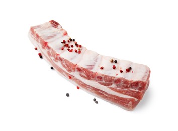 Raw pork ribs with peppercorns isolated on white