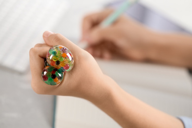 Woman squeezing colorful slime, closeup. Antistress toy