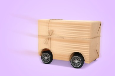 Image of Gift box on wheels against pale violet background. Order hurrying to client. Delivery service