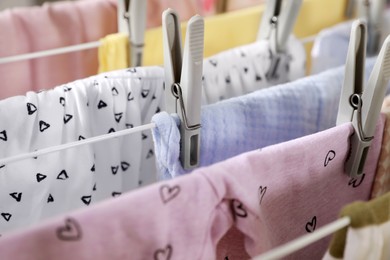 Clean laundry hanging on drying rack, closeup