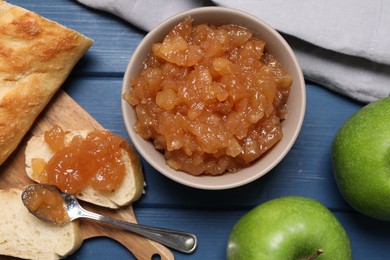 Flat lay composition with delicious apple jam on blue wooden table