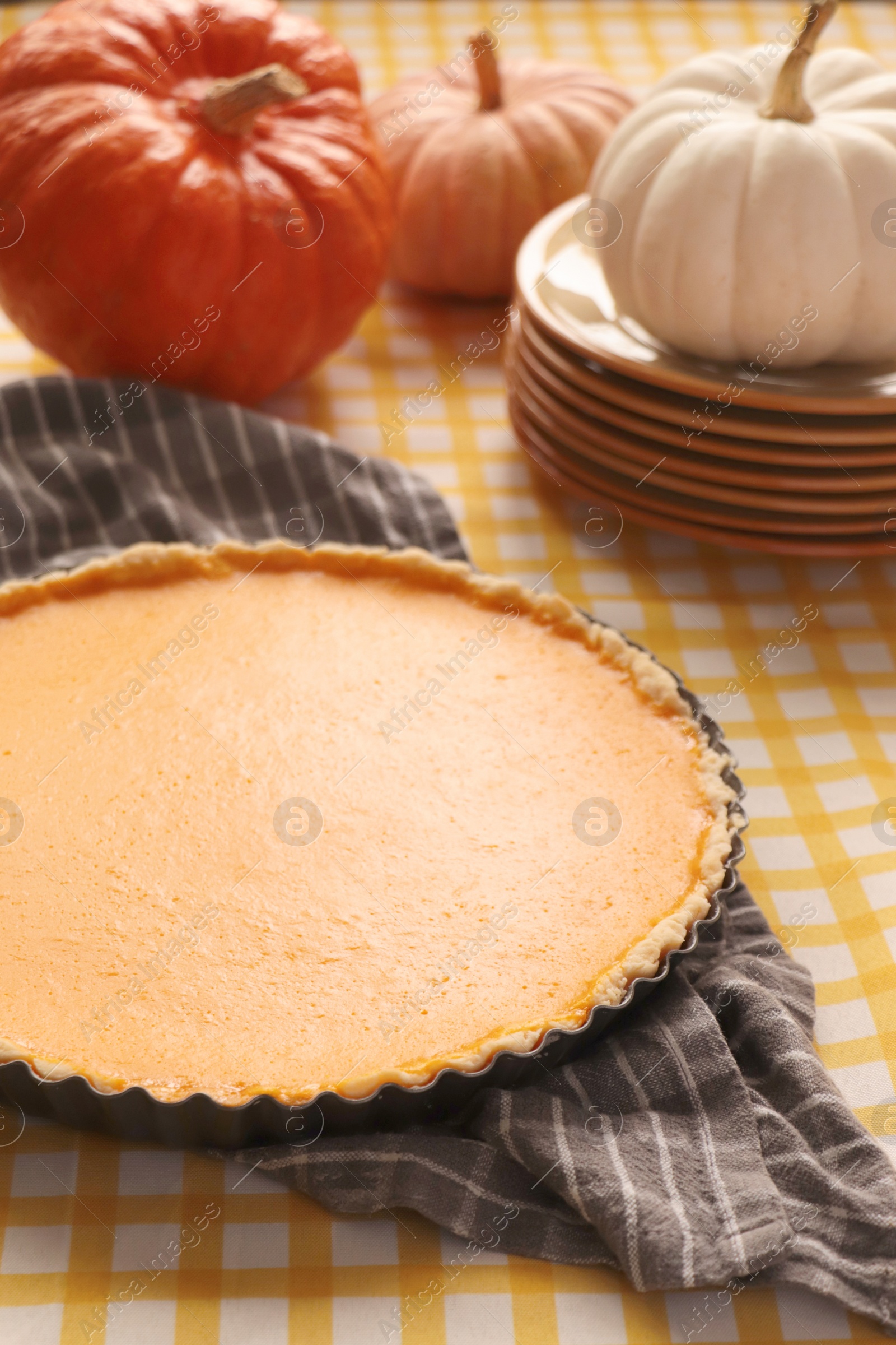 Photo of Delicious homemade pumpkin pie in baking dish on table