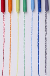 Photo of Colorful pastel chalks and lines on white background, flat lay. Drawing materials