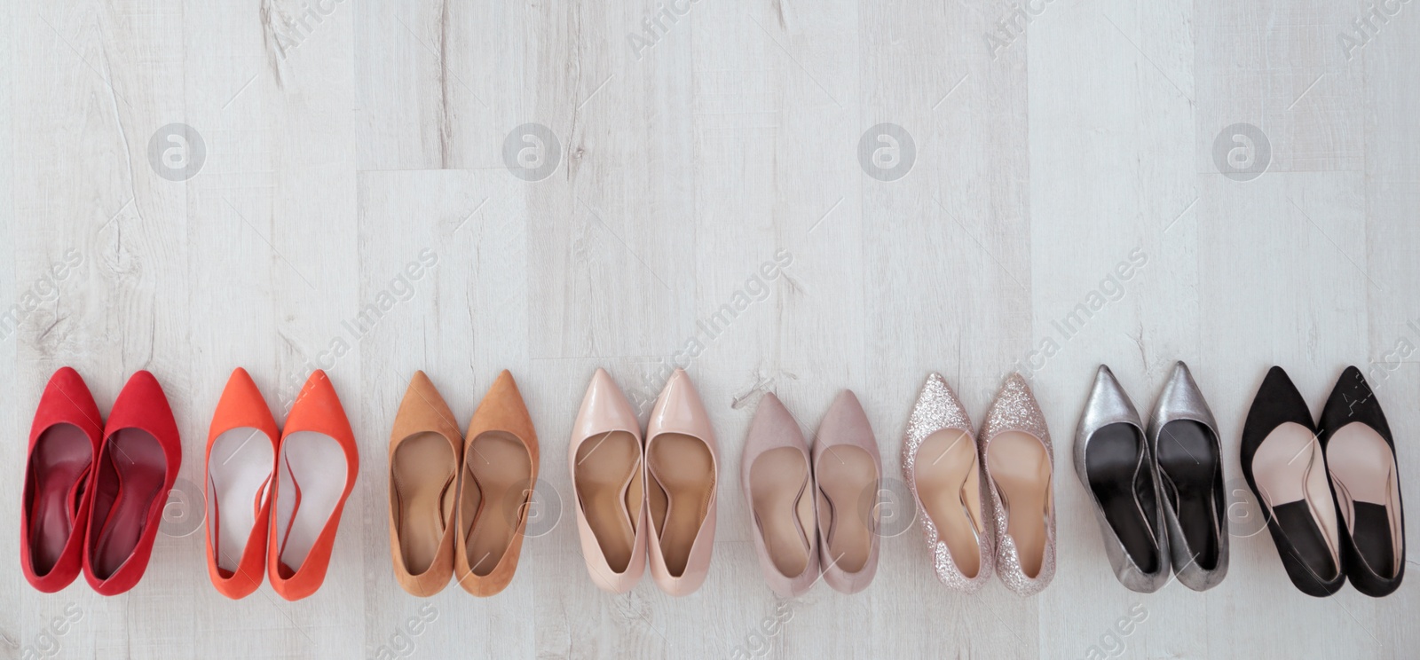 Photo of Collection of elegant shoes on floor, flat lay with space for text