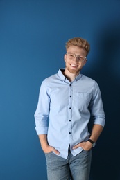 Photo of Portrait of handsome young man on blue background