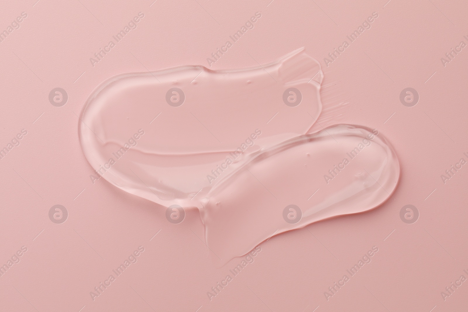 Photo of Sample of clear cosmetic gel on pink background, top view