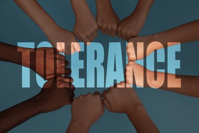 Image of Tolerance, support and cooperation concept. Group of multiracial people joining fists together on light blue background, closeup