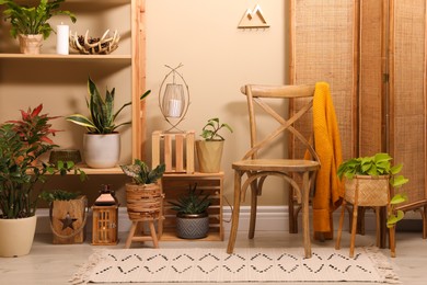 Photo of Room interior with wooden furniture, houseplants and stylish accessories