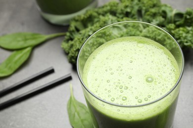 Photo of Tasty fresh kale smoothie on grey table, closeup