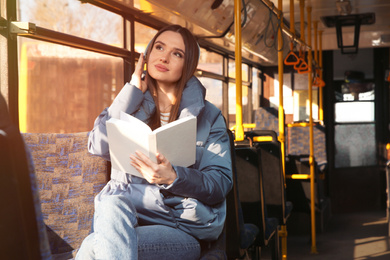 Photo of Woman listening to audiobook in trolley bus