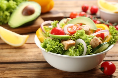 Photo of Delicious fresh chicken salad served on wooden table, closeup