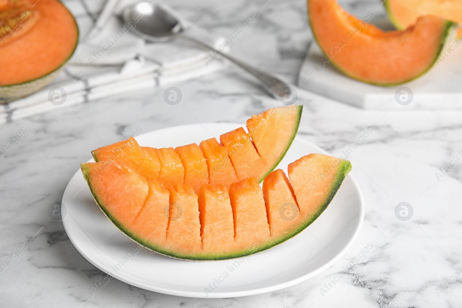 Photo of Slices of ripe cantaloupe melon on marble table