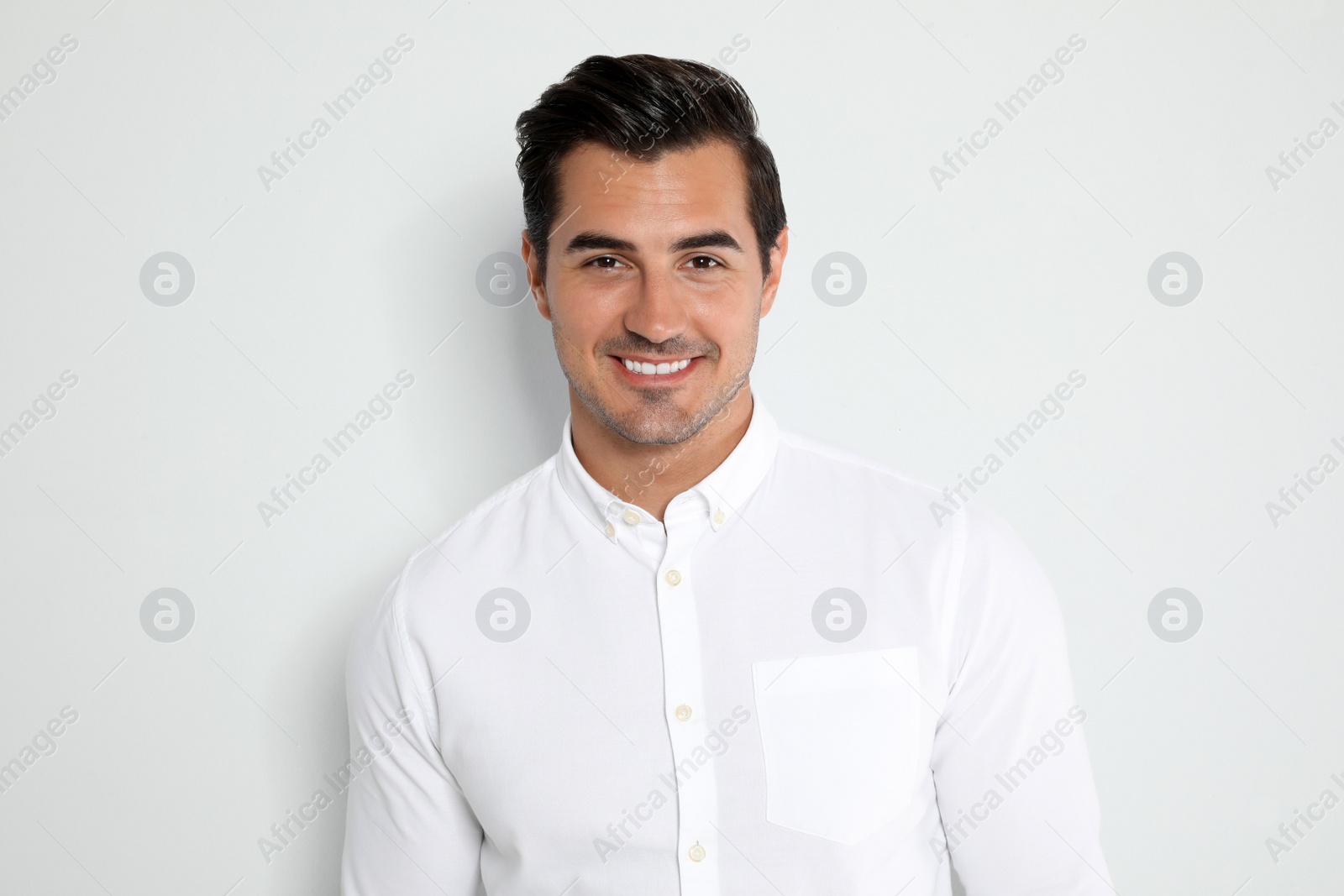 Photo of Portrait of handsome young man on light background