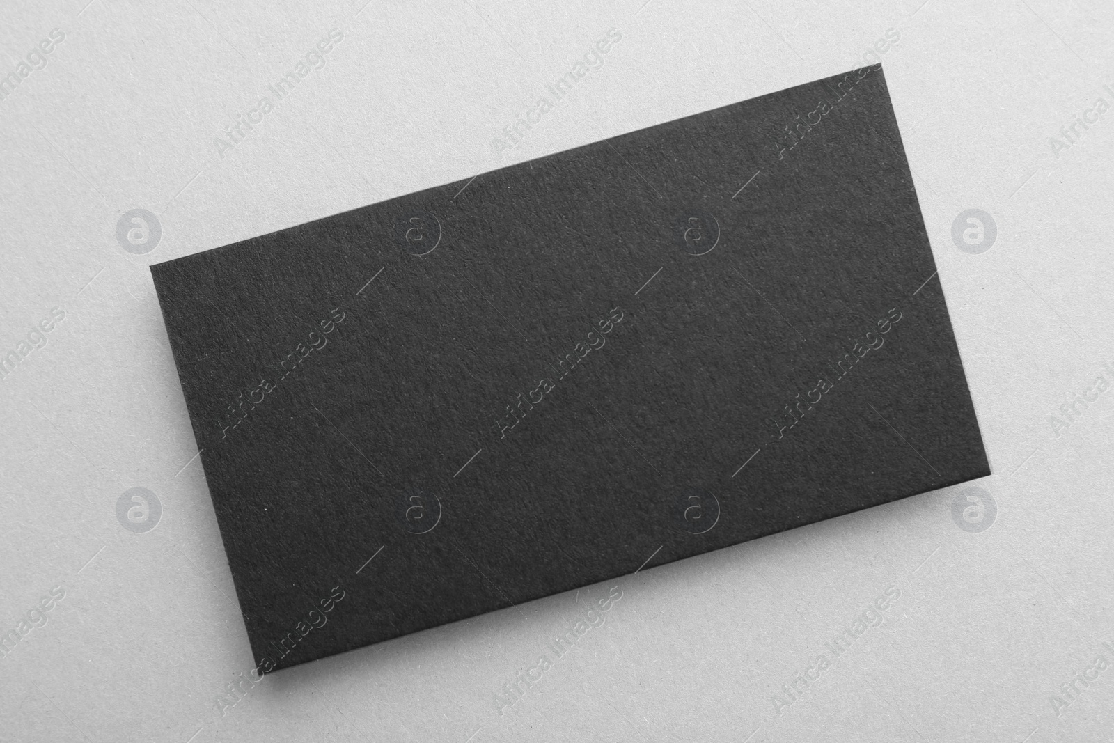 Photo of Blank black business card on light background, top view. Mockup for design