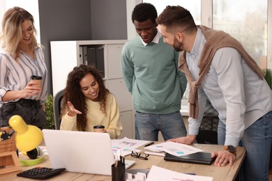 Photo of Team of employees working together in office. Startup project