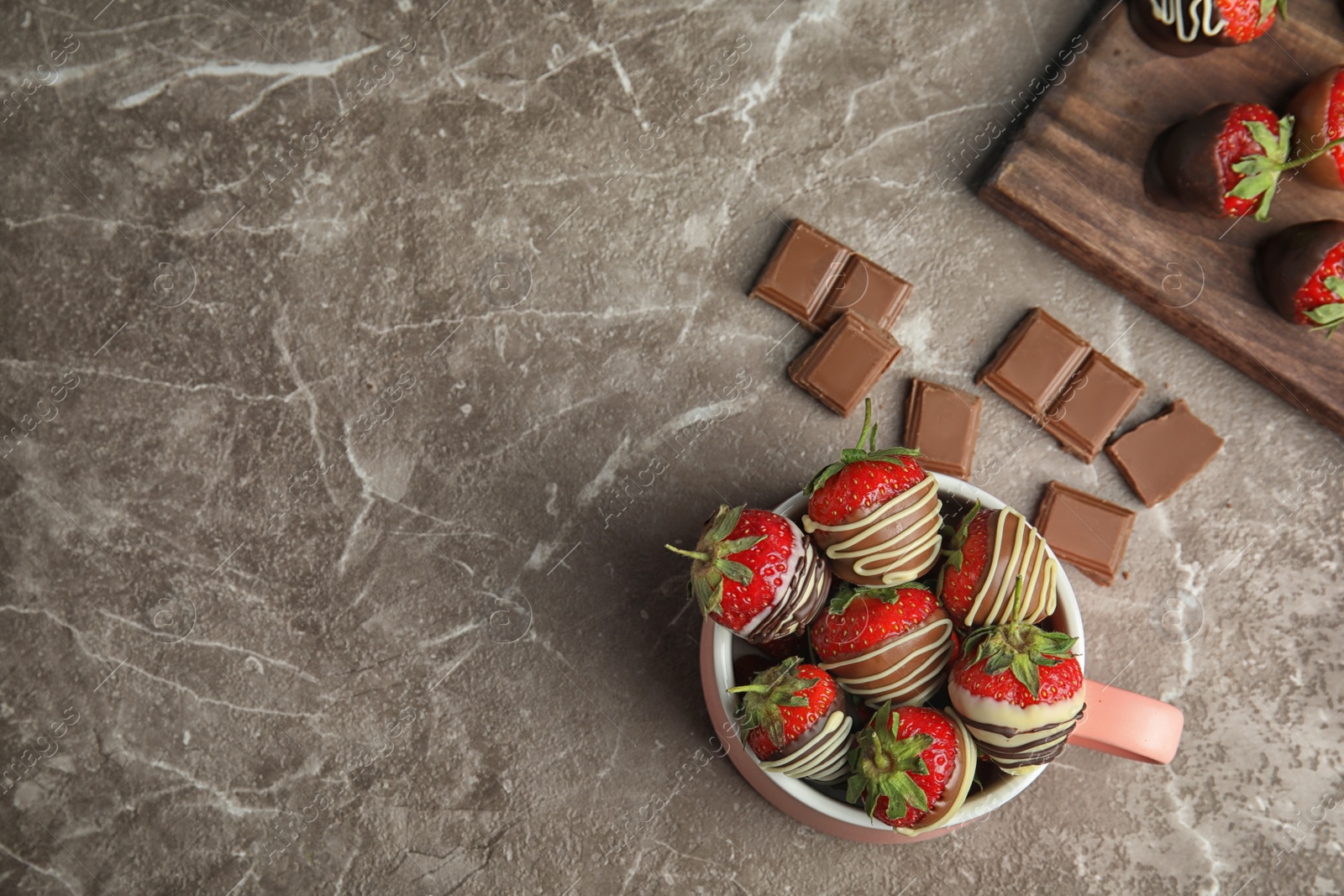 Photo of Flat lay composition with chocolate covered strawberries on grey background