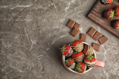 Photo of Flat lay composition with chocolate covered strawberries on grey background