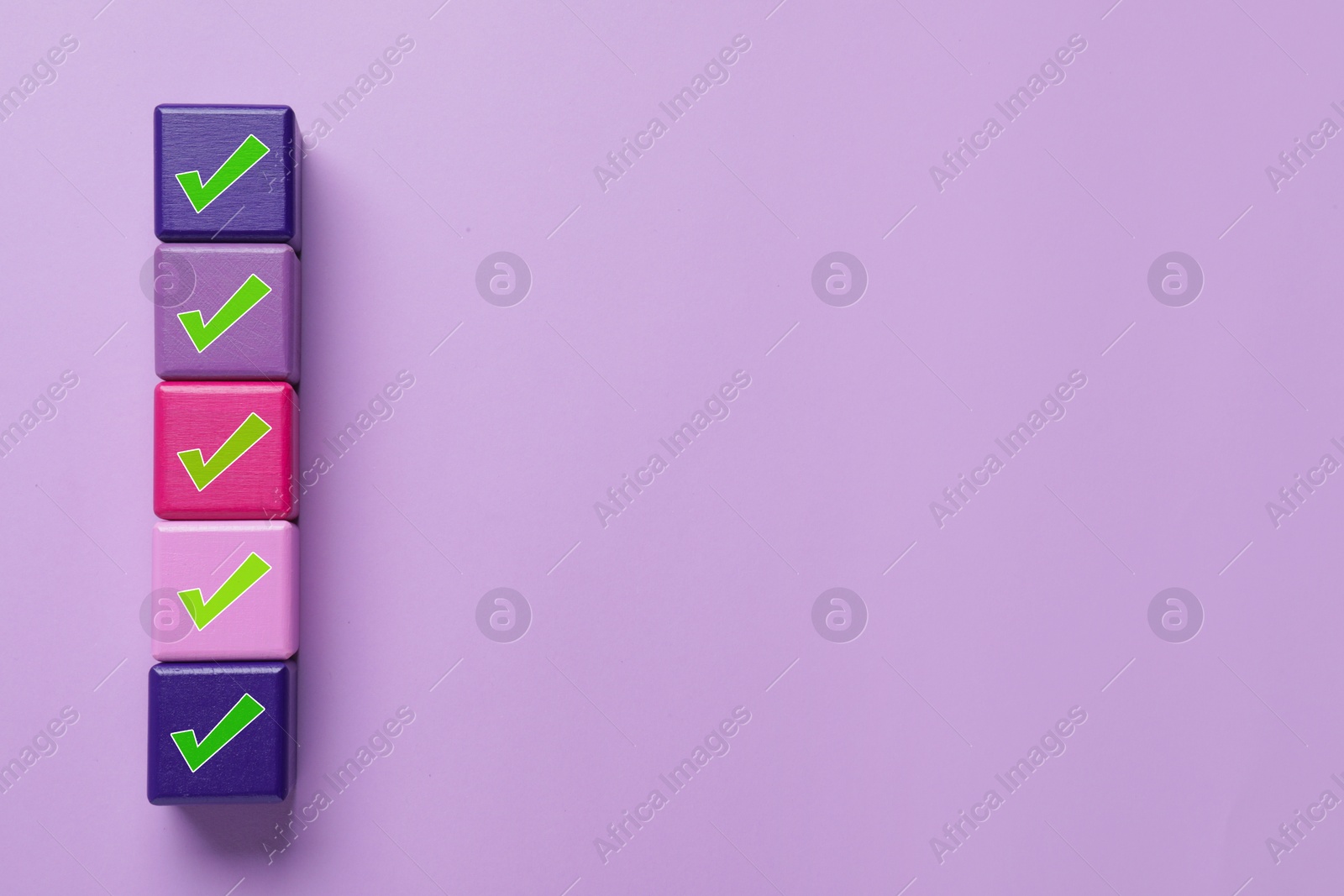 Image of Cubes with check marks on light violet background, top view. Space for text