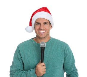 Happy man in Santa Claus hat with microphone on white background. Christmas music