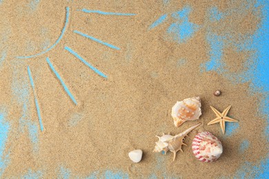 Photo of Beautiful starfish, shells and sun drawing on sand on blue background, flat lay