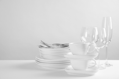 Set of clean dishes on white table