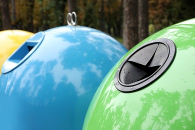 Waste sorting bins in park on autumn day, closeup