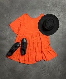 Stylish dress, shoes and hat on grey stone background, flat lay