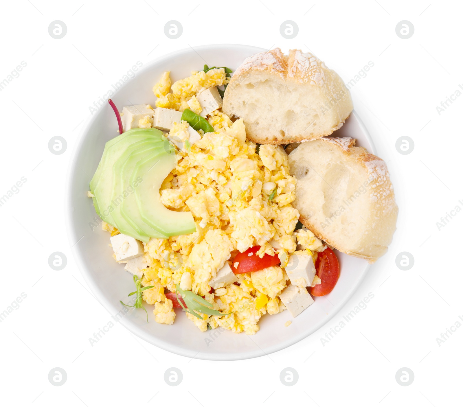Photo of Bowl with delicious scrambled eggs, tofu, avocado and slices of baguette isolated on white, top view