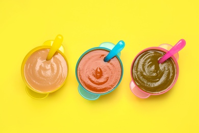 Photo of Healthy baby food on yellow background, flat lay