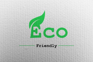 Image of Phrase Eco Friendly written on white canvas, top view