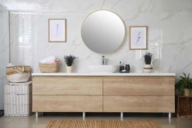 Mirror and counter with vessel sink in stylish bathroom interior. Idea for design