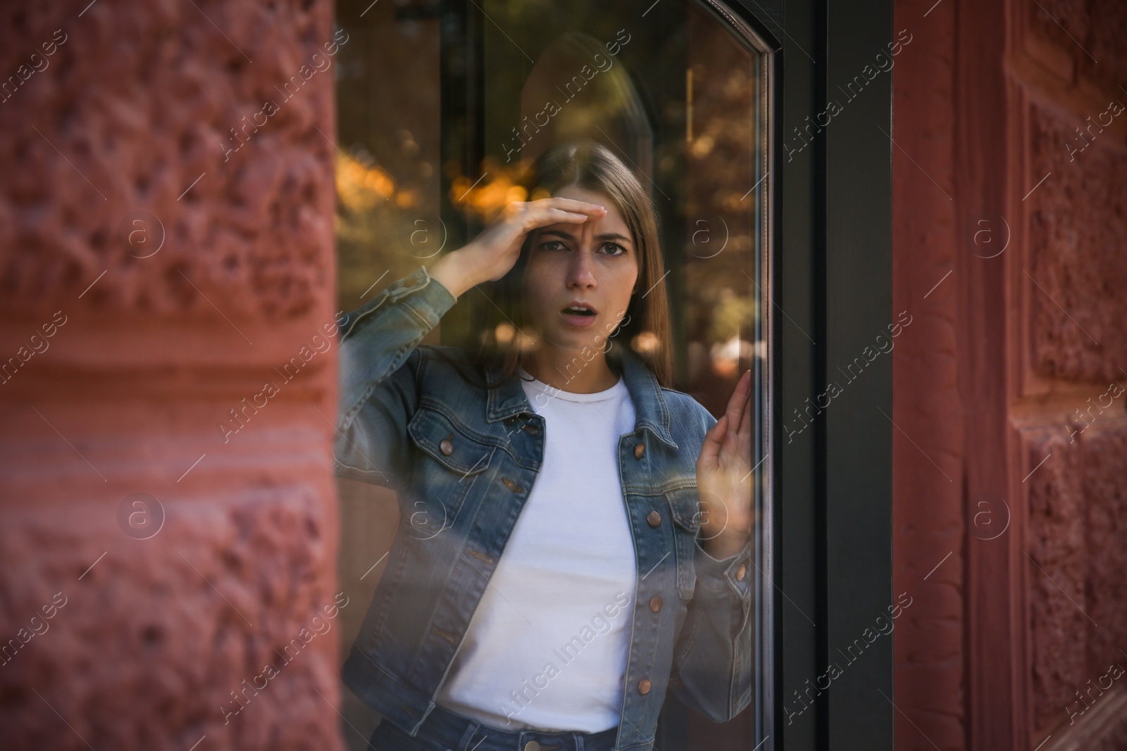 Photo of Jealous woman spying on ex boyfriend outdoors