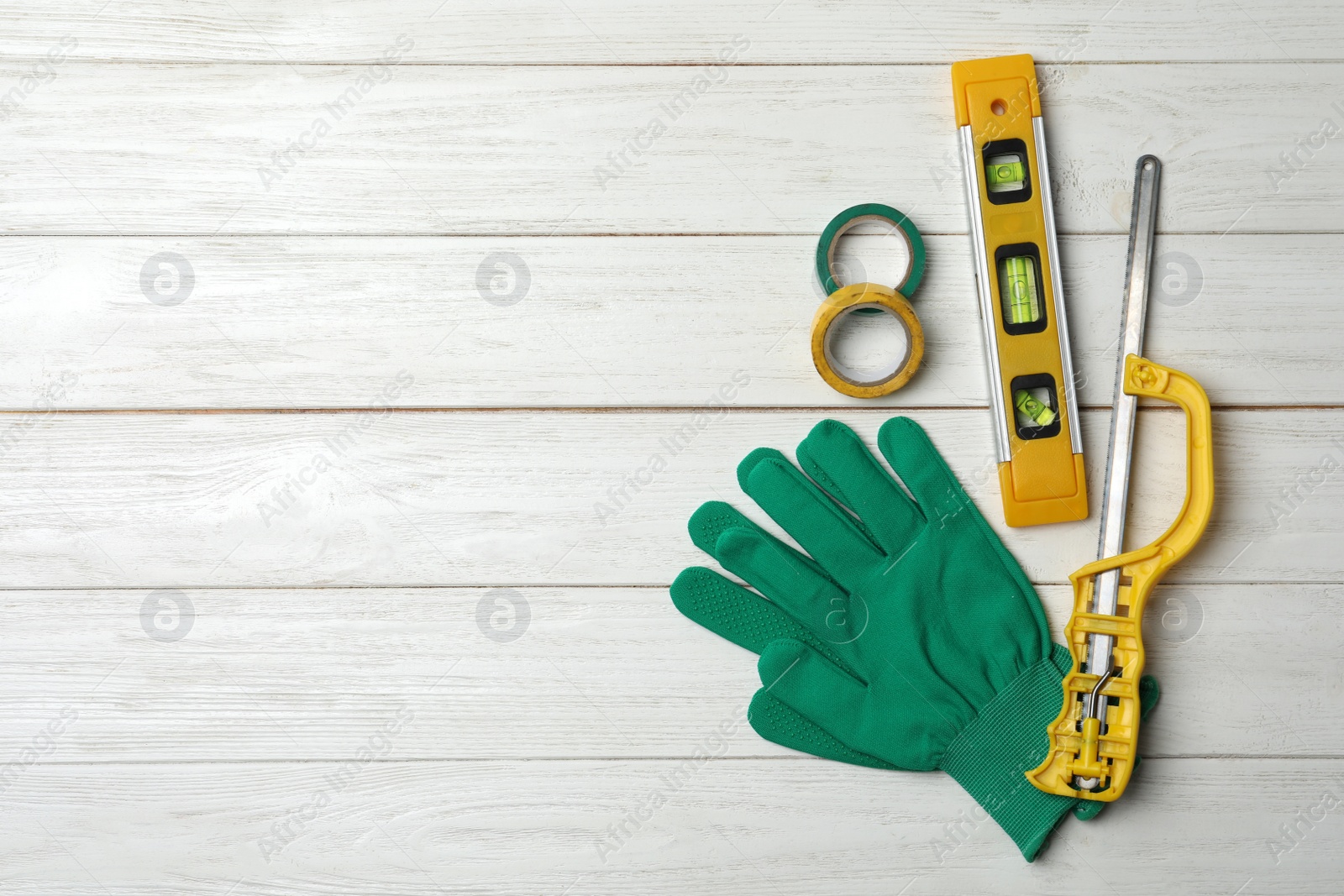 Photo of Flat lay composition with carpenter's tools on white wooden background. Space for text