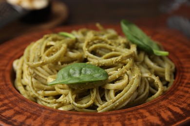 Tasty pasta with spinach on table, closeup