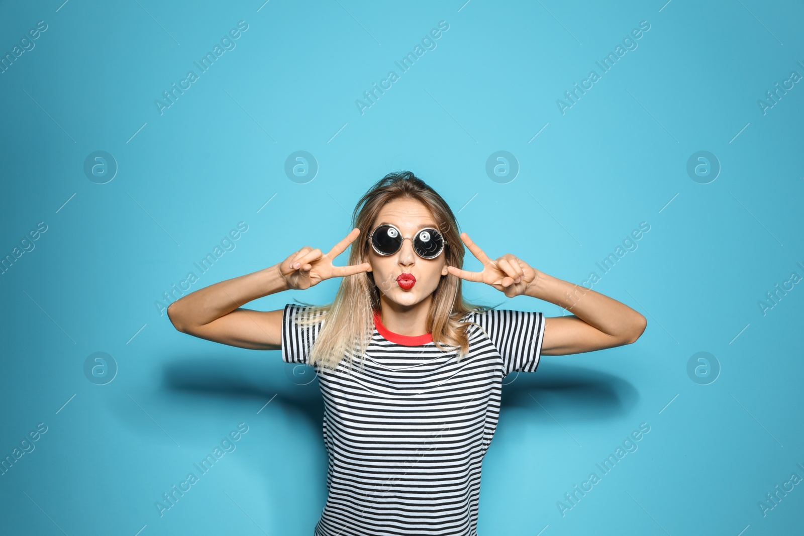 Photo of Beautiful young woman with healthy long blonde hair on color background