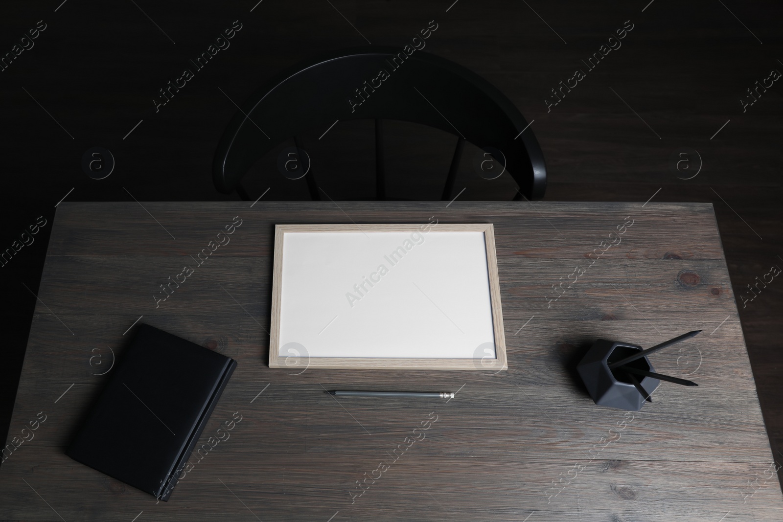 Photo of Modern wooden table with stationery and chair indoors