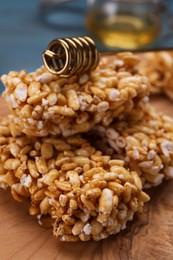 Photo of Wooden board with puffed rice bars (kozinaki), closeup