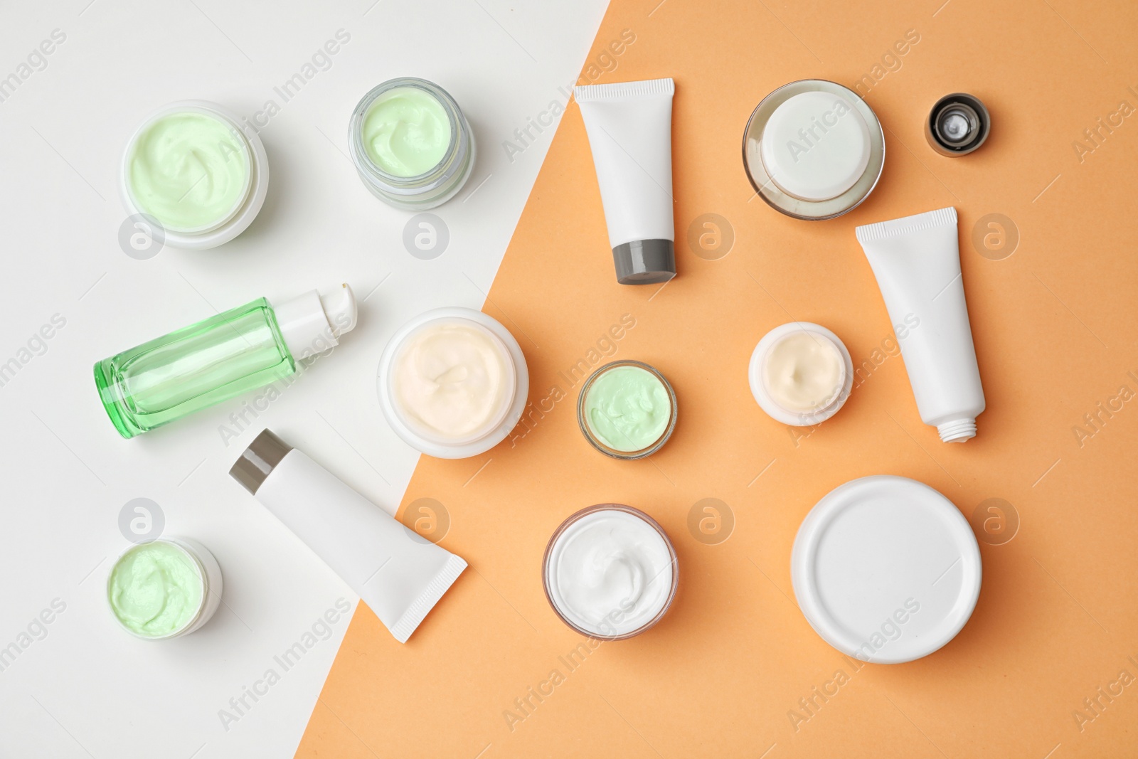 Photo of Flat lay composition with cosmetic products on color background