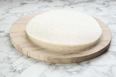 Photo of Stack of dry rice paper on marble table