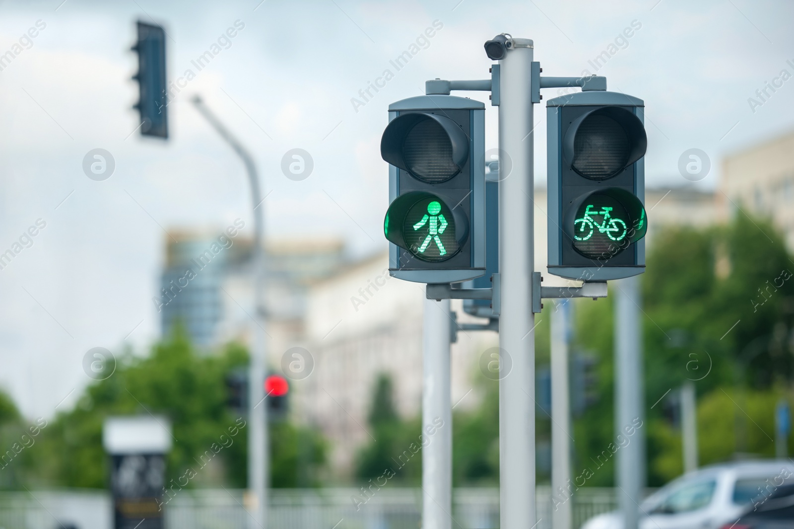 Photo of Pedestrian and bicycle traffic light on city street, space for text