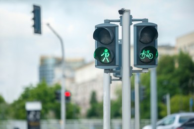 Photo of Pedestrian and bicycle traffic light on city street, space for text