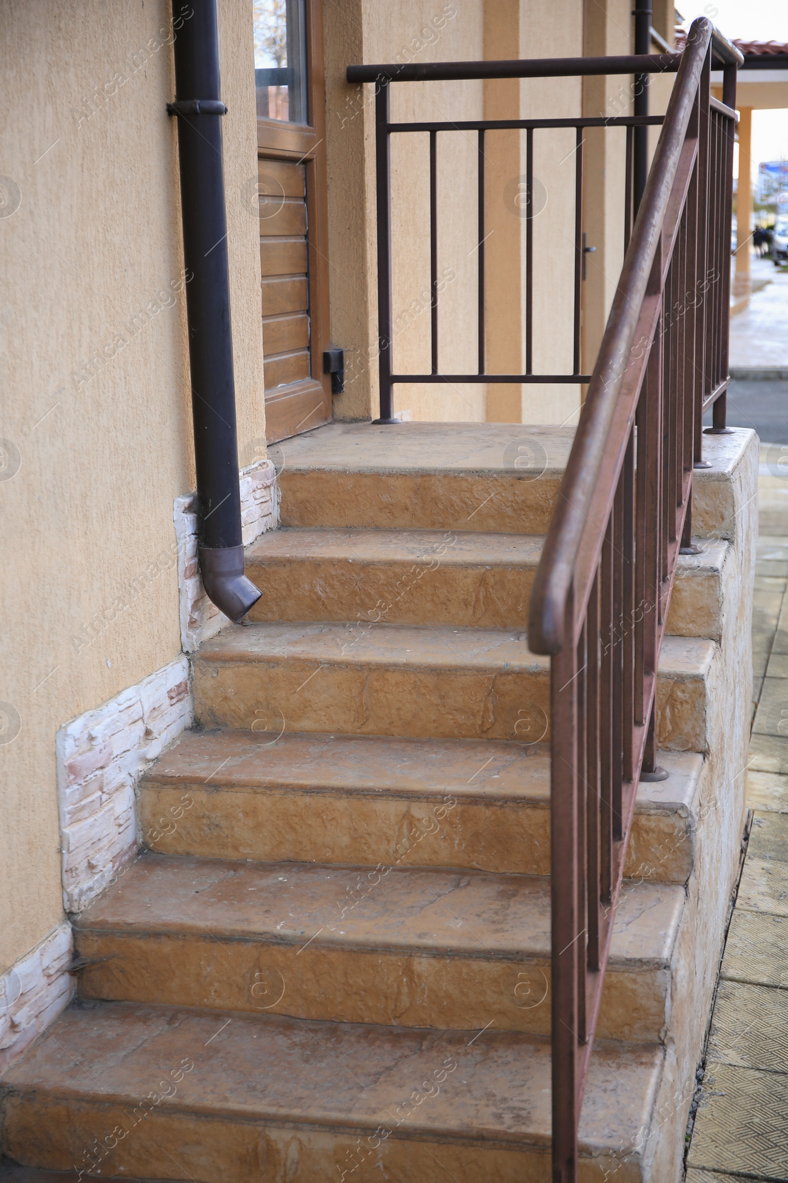 Photo of View of beautiful stairs with metal handrail near house outdoors