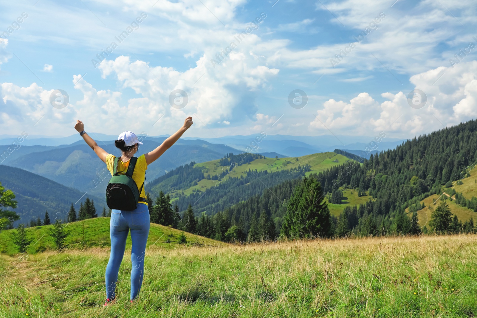 Photo of Woman with backpack in wilderness. Mountain landscape