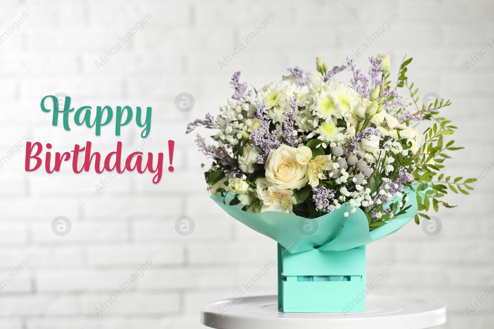 Image of Happy Birthday! Beautiful bouquet of flowers in decorative crate on table 