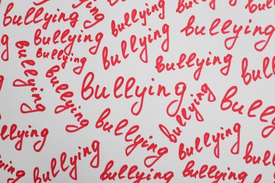 Words Bullying written on white background, top view