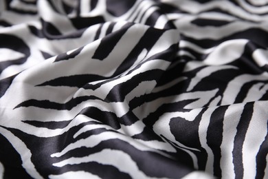 Photo of Texturebeautiful fabric with animal pattern as background, closeup