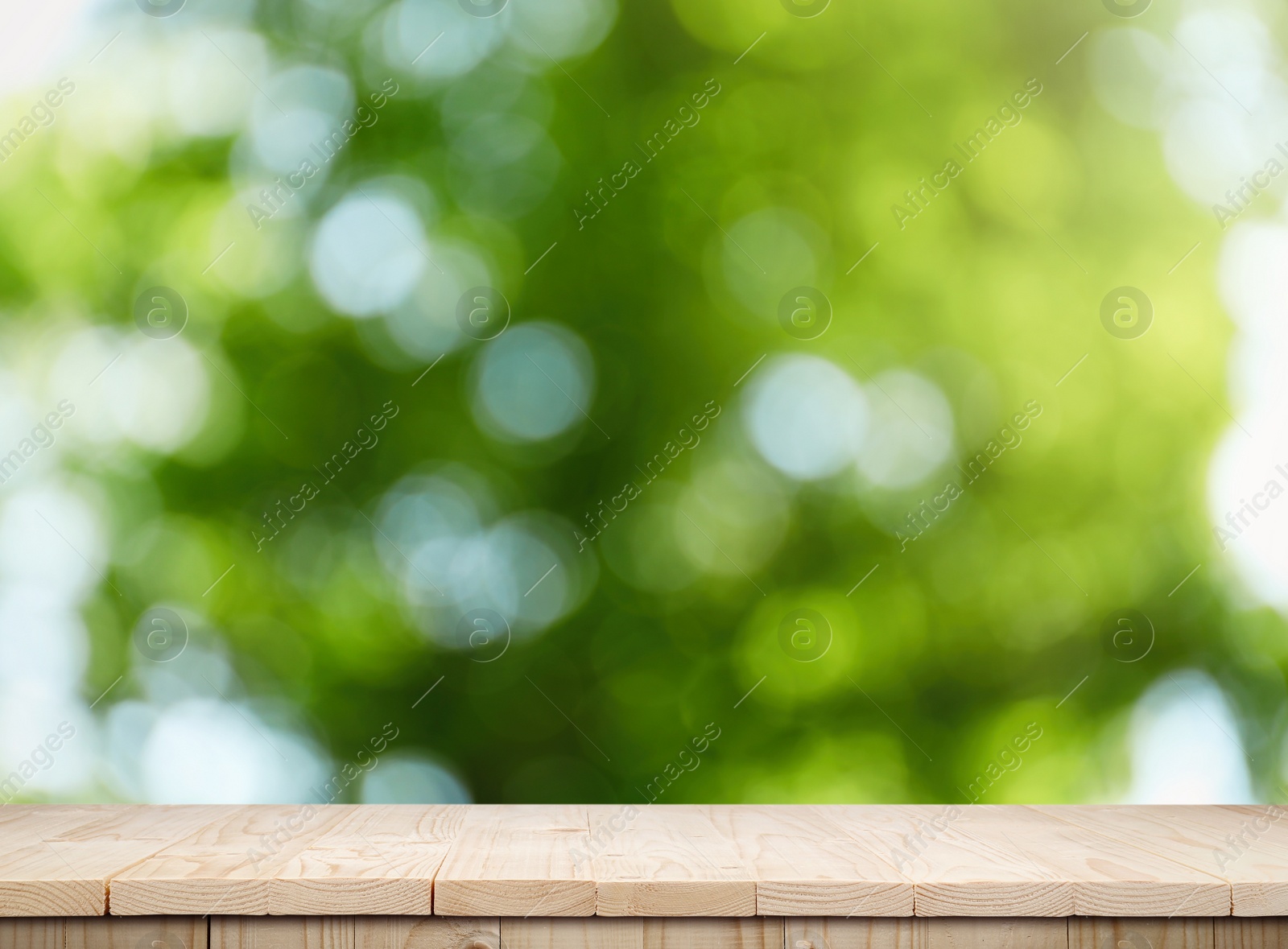 Image of Empty wooden surface against blurred green background. Space for design