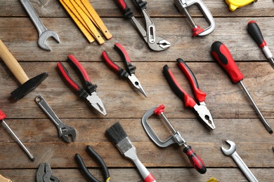 Photo of Flat lay composition with construction tools on wooden background