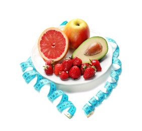 Photo of Plate with different tasty fruits and measuring tape on white background. Healthy diet